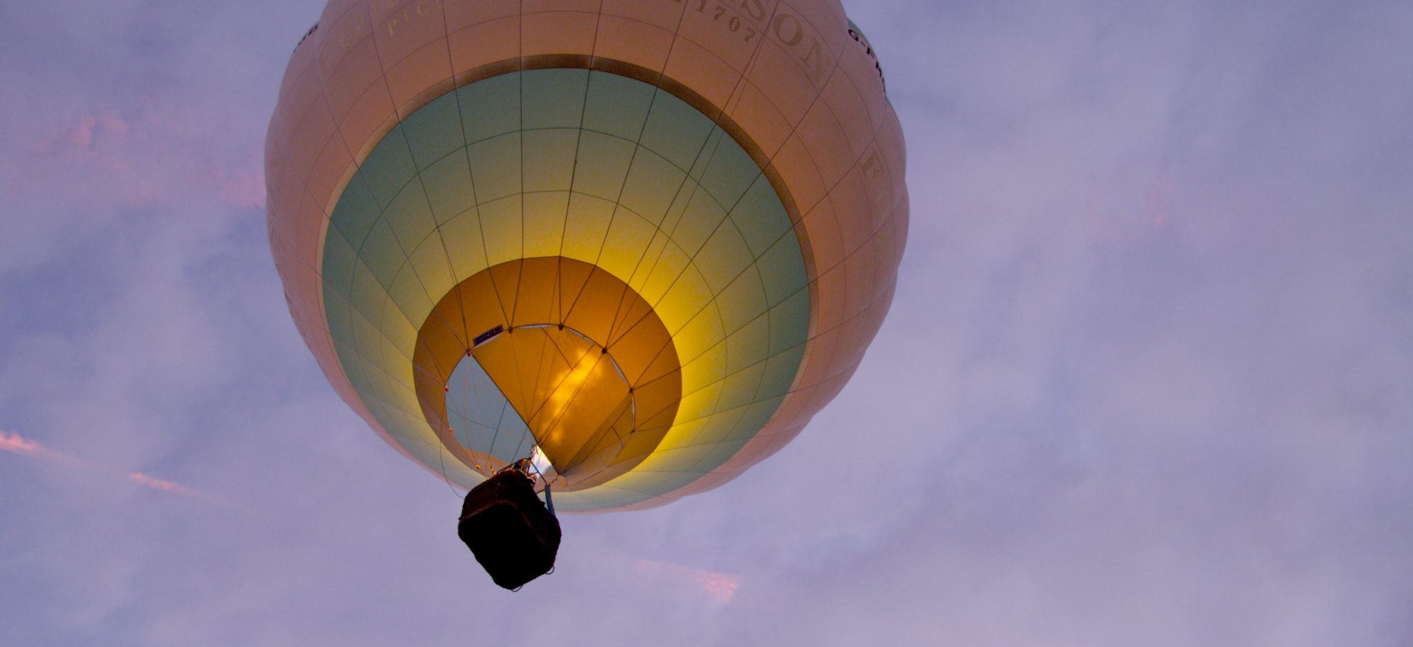 Dawn start - a balloon lifting into the early morning sky in a long-distance race near Bristol, UK.