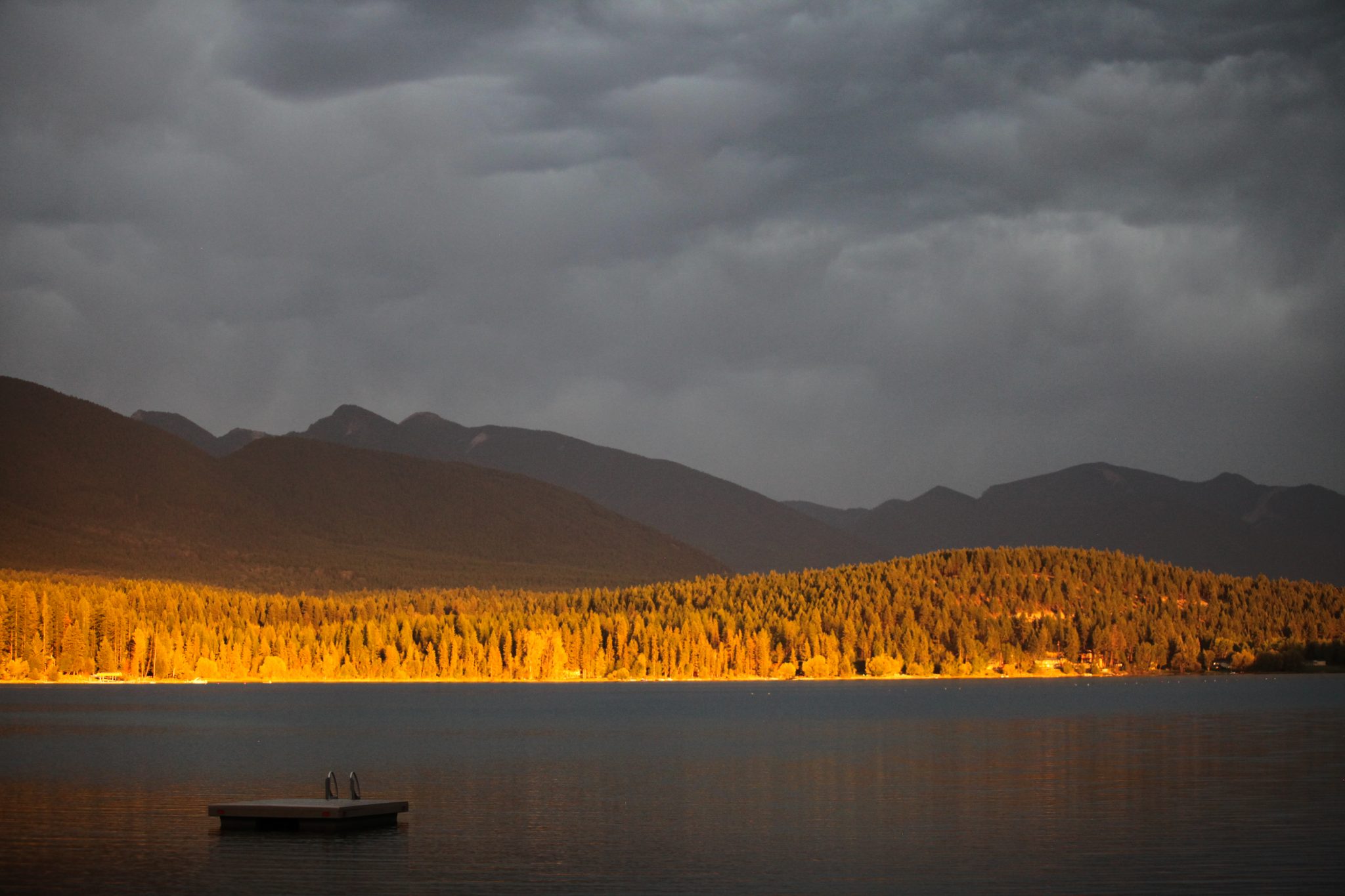 Golden light and grey skies over Glenn Lake, Montana, USA.